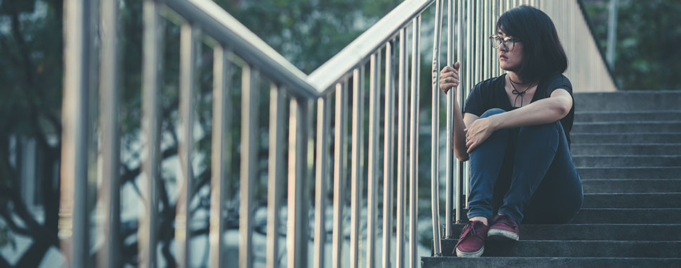 Woman sitting alone on the stairs