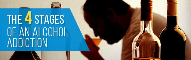 silhouette of anonymous alcoholic person drinking behind bottles of alcohol