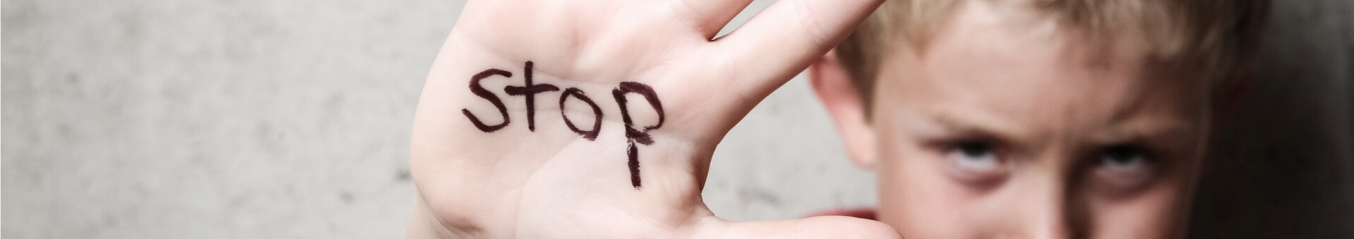 boy with stop sign on his hand