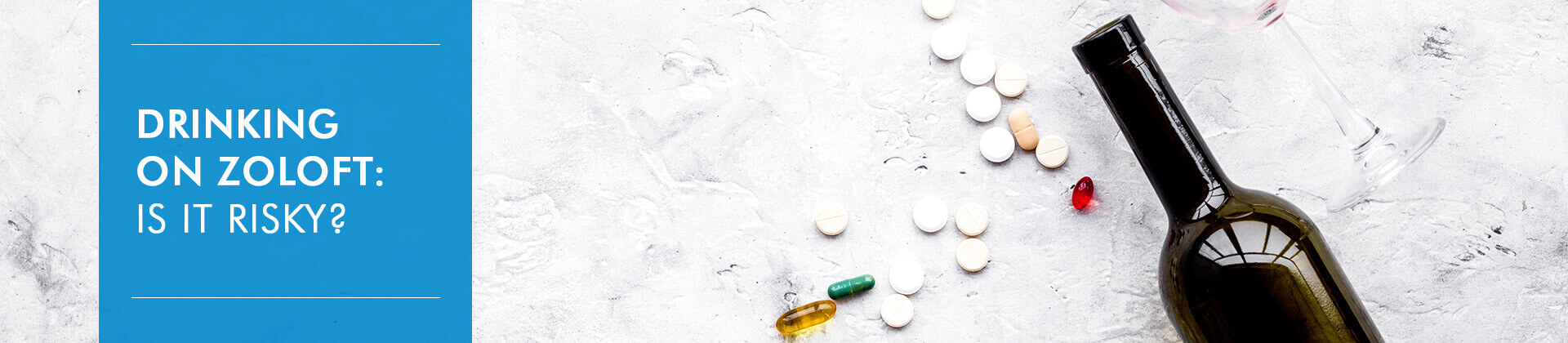 Bottle of wine, glass and pills on grey background
