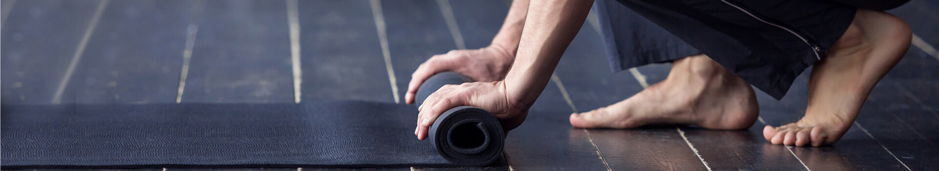 yogi man rolling the mat after yoga practice