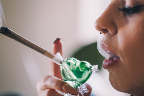 girl smoking weed from a bubbler