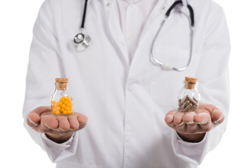 doctor holding two types pf pills