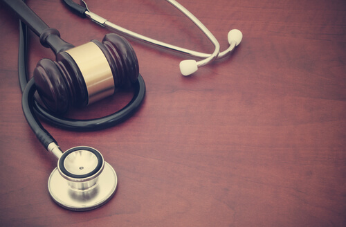 Wooden gavel and stethoscope on the table