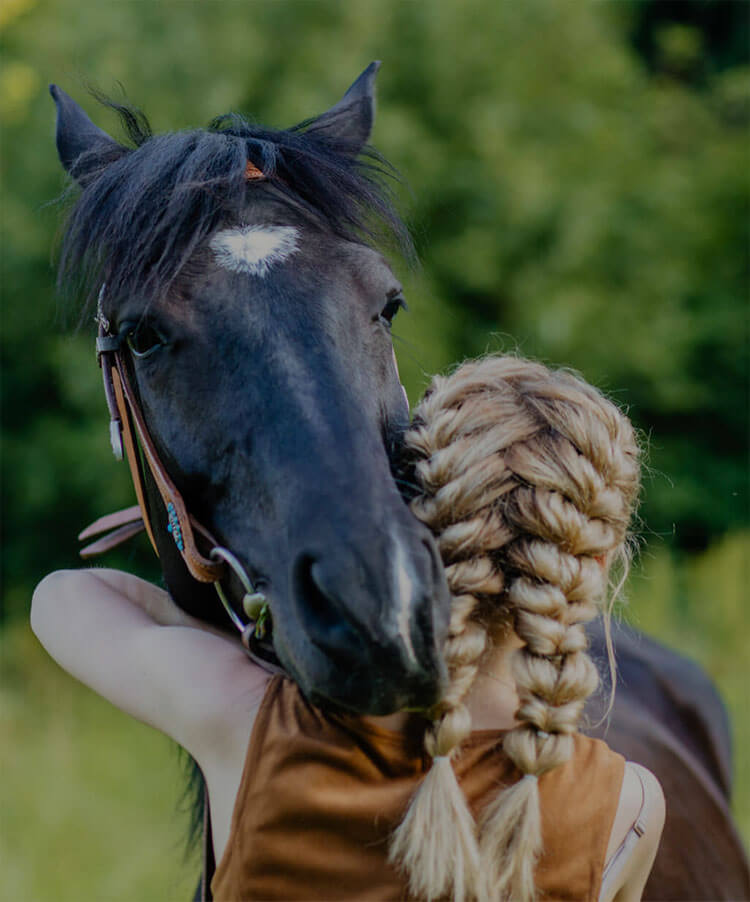 woman hugging a horse