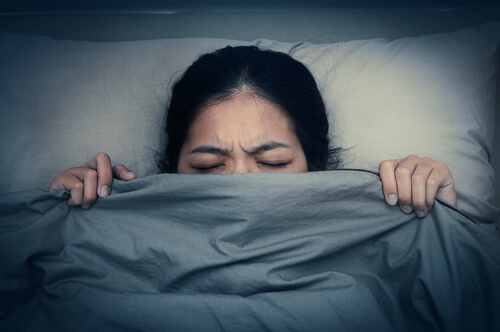 woman in bed trying to fall asleep