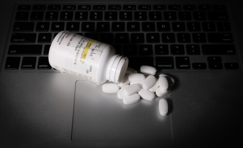 prescription pills on the laptop