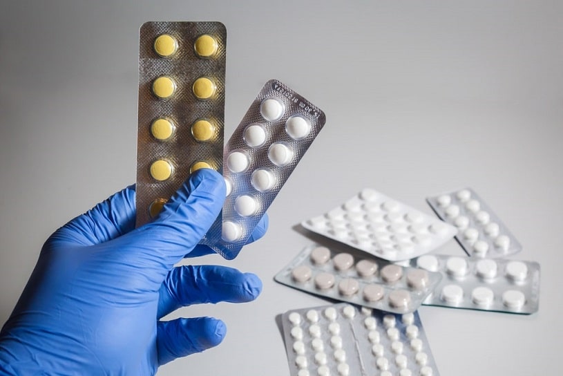 Doctor holding medicine pills.