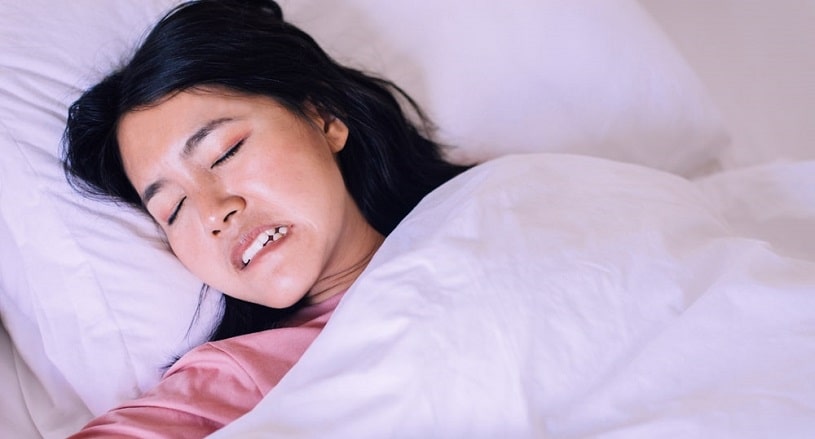 Woman grinding her teeth in sleep.