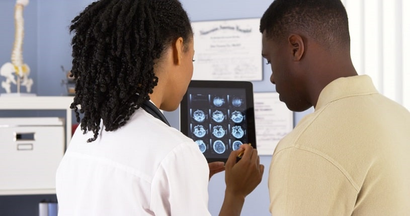 Doctor checks brain scan results.