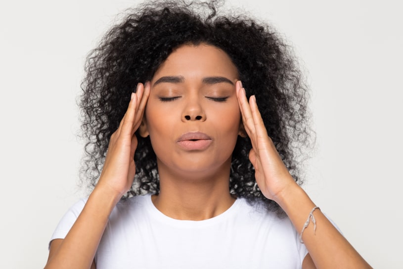 Nervous african woman breathing calming down.