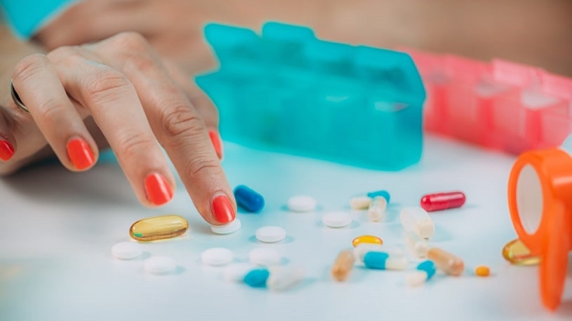 Female patient counting adderall pills.