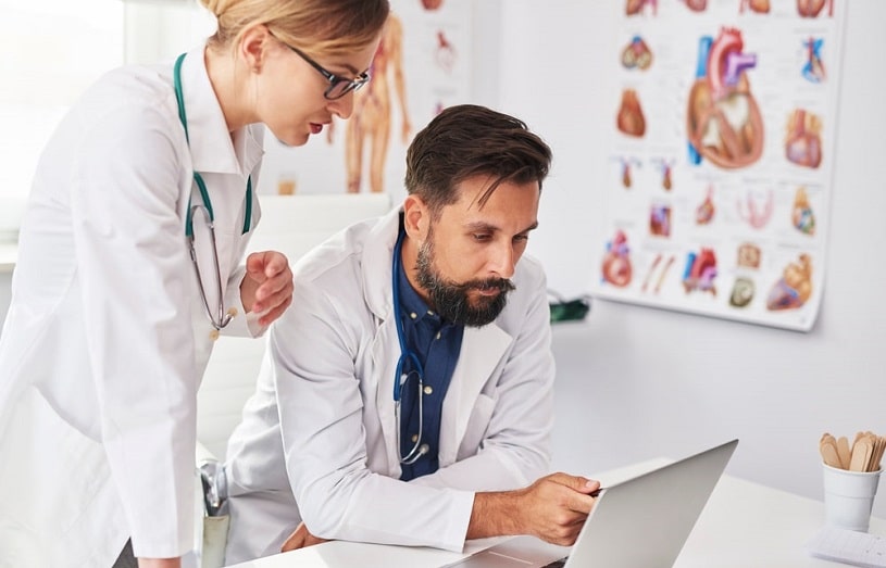 Two busy doctors over the laptop