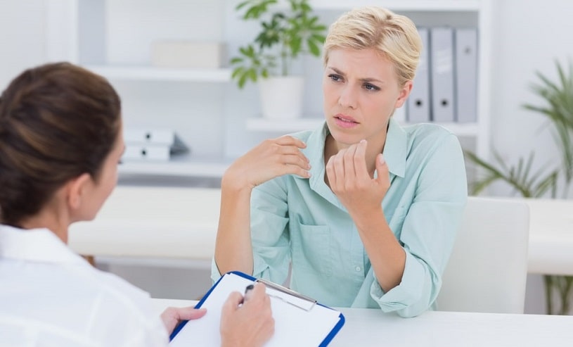 patient speaking to a doctor at a consultation.