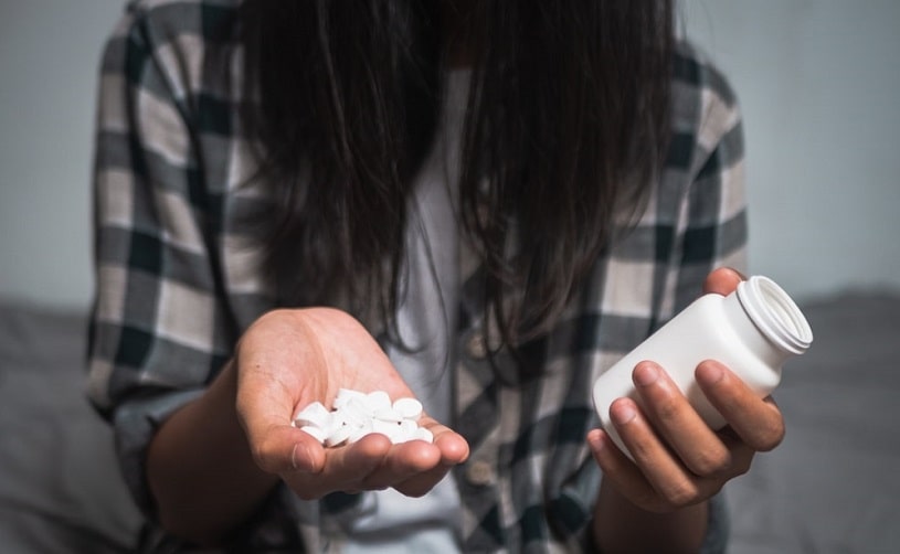 Woman holding xanax in hands.