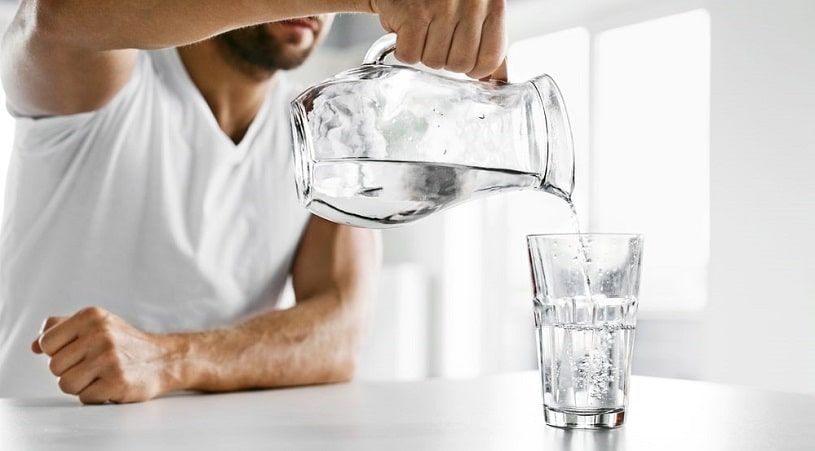 Man drinking water to eliminate percocet from the system.