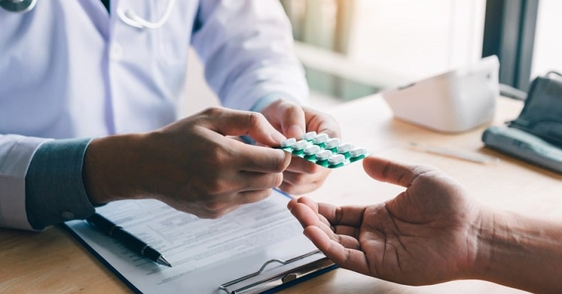 Doctor giving fentanyl pills to a patient.