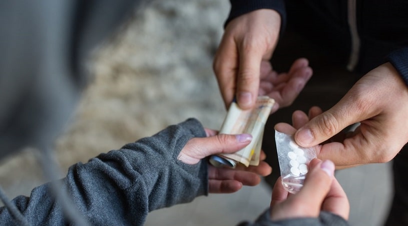 Man buying drugs in the street.