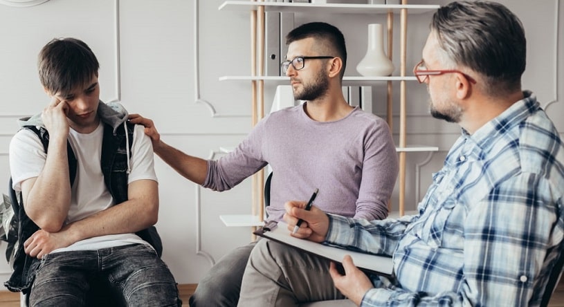 Three man at a behavioral therapy meeting.