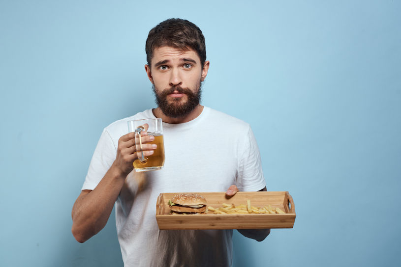 Man with beer and fast food.