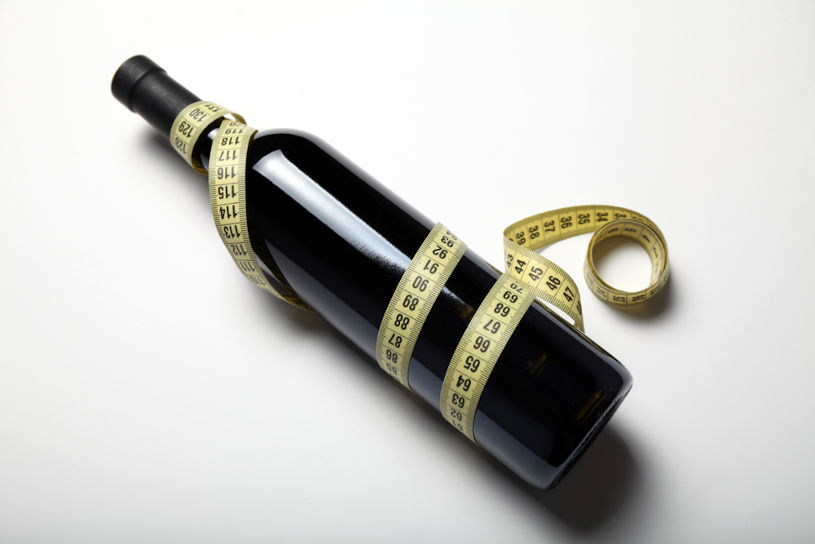 A bottle of red wine and measuring tape.