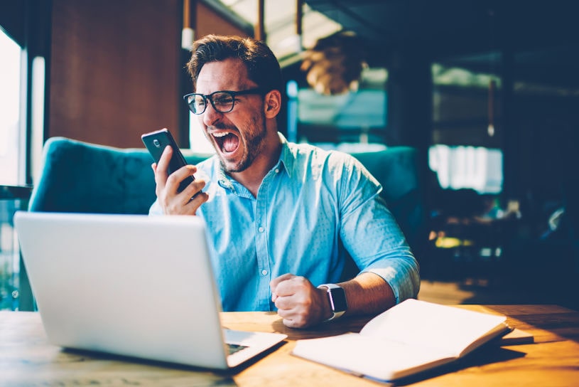 Man screams with aggression in mobile phone.