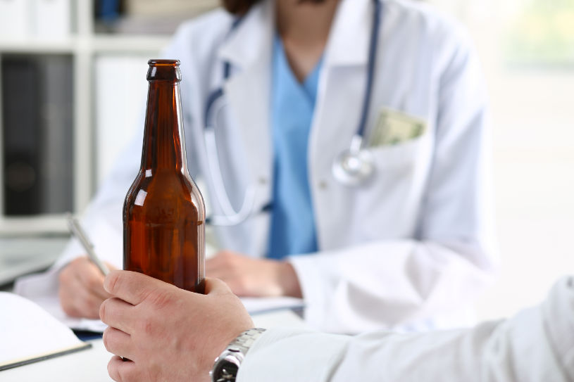 A doctor provides consultation to a patient with alcohol addiction.