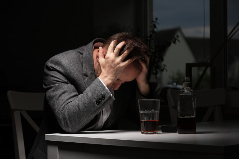 A man is experiencing side effects of alcohol withdrawal.