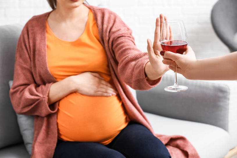 A pregnant woman says no to alcohol.