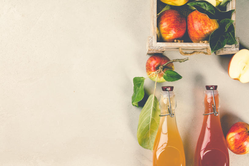 Apples and bottles of fresh juice, how to detox from alcohol at home.