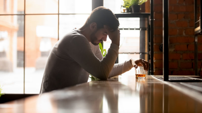 Depressed man is trying to quit drinking alcohol.