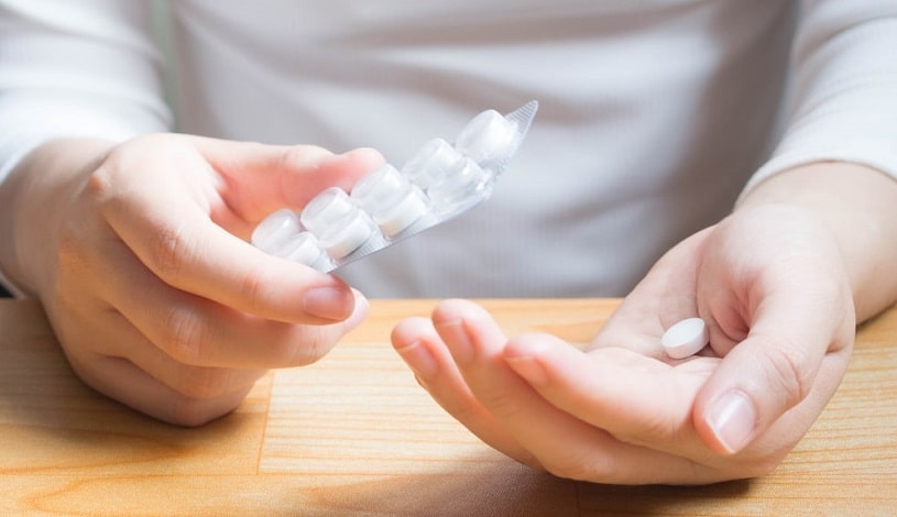 Patient taking a medicine and holding a blister.