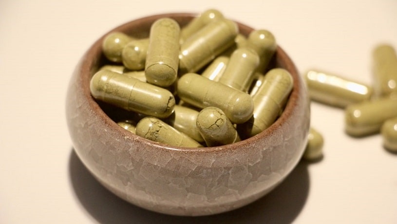 A bowl of Kratom capsules.
