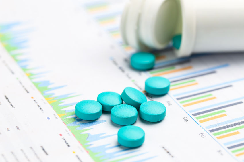 Lexapro tablets outside the white bottle on statistic chart background.