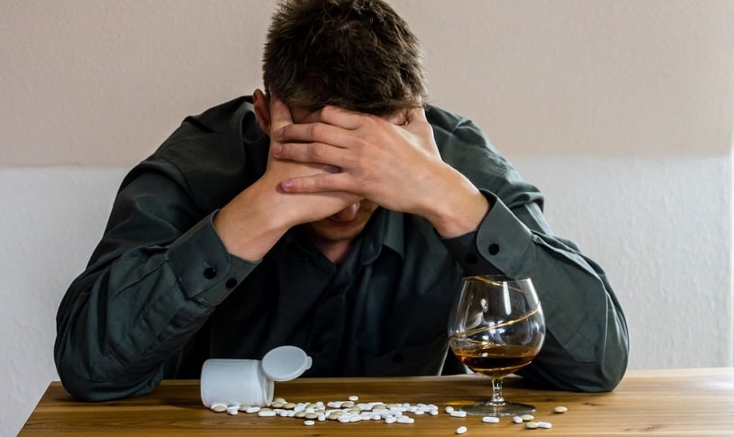 Man drinking alcohol with blood thinners feeling unwell.