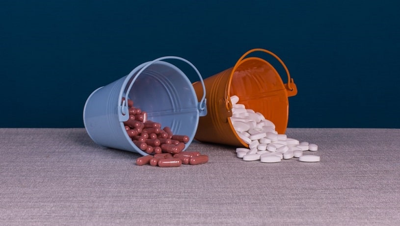 Zoloft vs Prozac pills in small buckets.