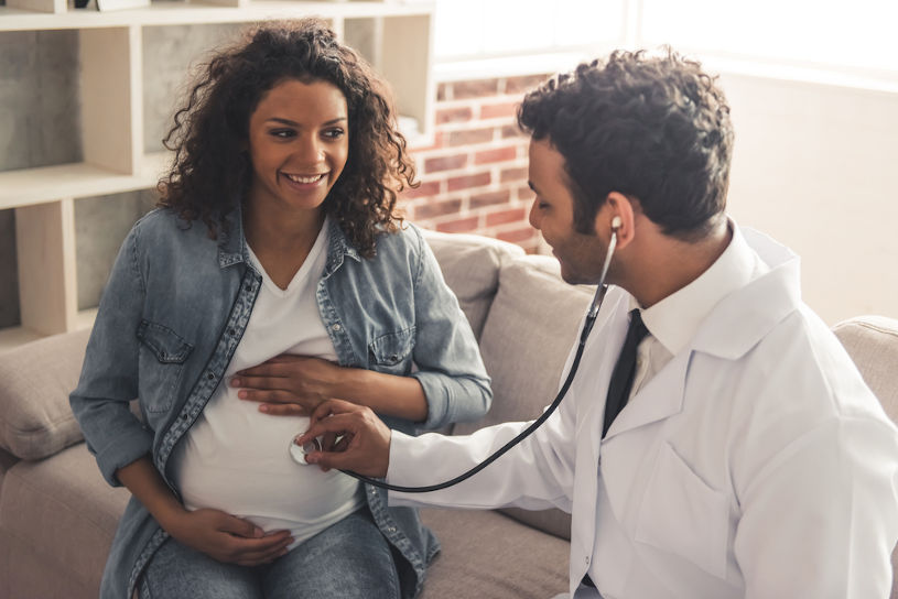 Pregnant woman and doctor.