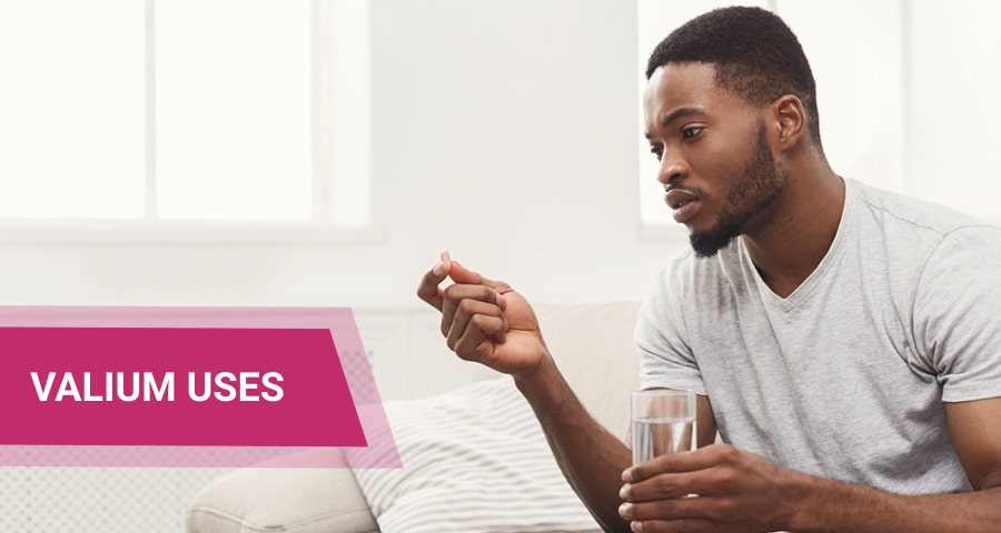 Man taking valium pill and a glass of water.