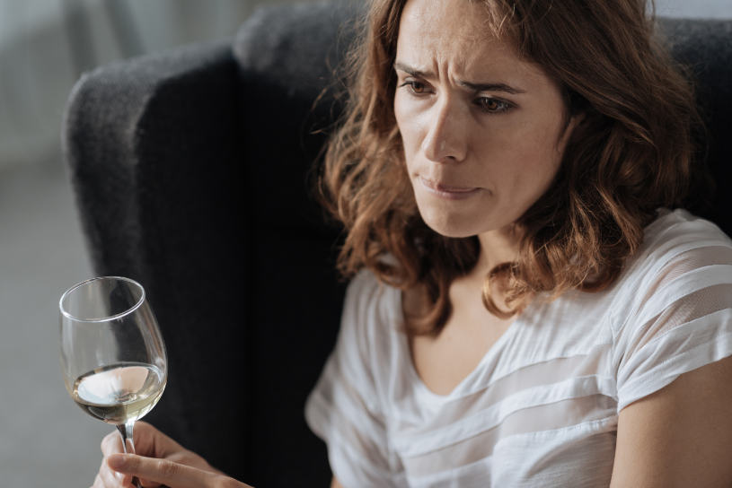 Woman with a glass of wine in her hand.