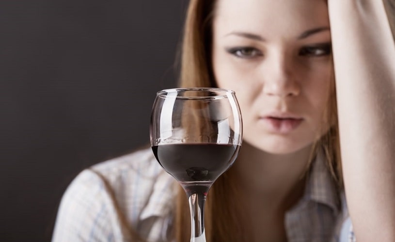 Woman feeling dizzy after drinking alcohol.