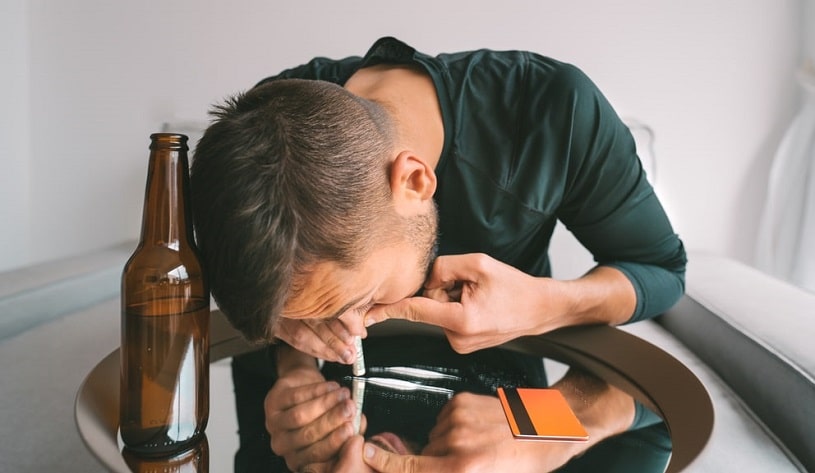 Man drinking beer and snorting Klonopin crushed pills.