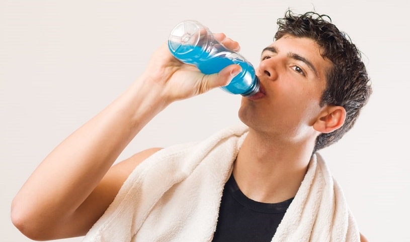 Man drinking an energy drink with caffeine.