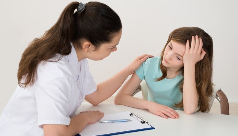 Doctor talking to a child with ADHD.