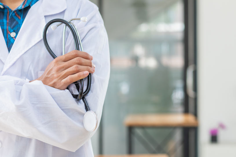 A medical worker stands near the window.