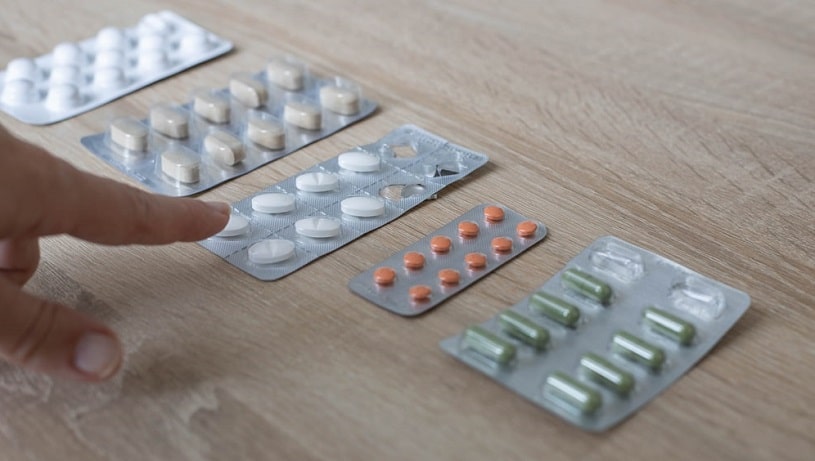 Woman's hand shows on the selected pill.