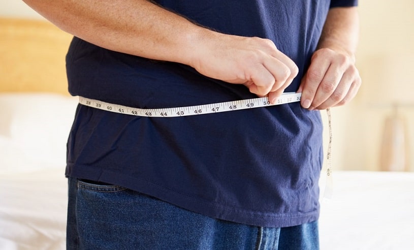 Man measuring his waist.