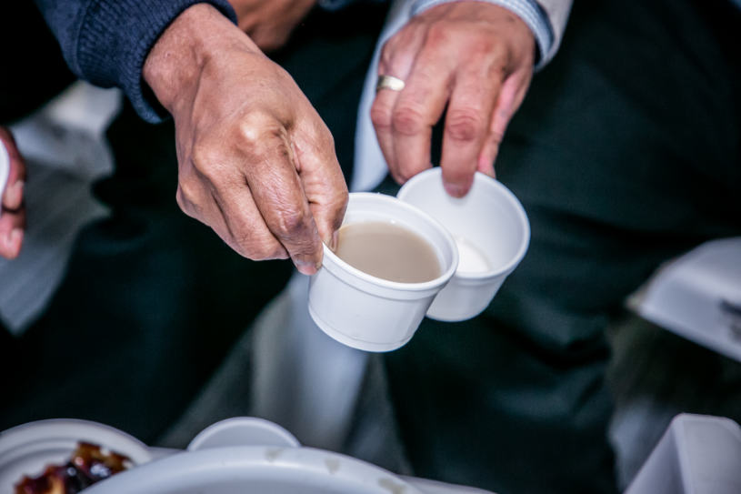 Men holding cups with Kava tea.