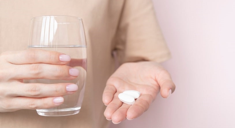 Close up of a woman hands with pills.