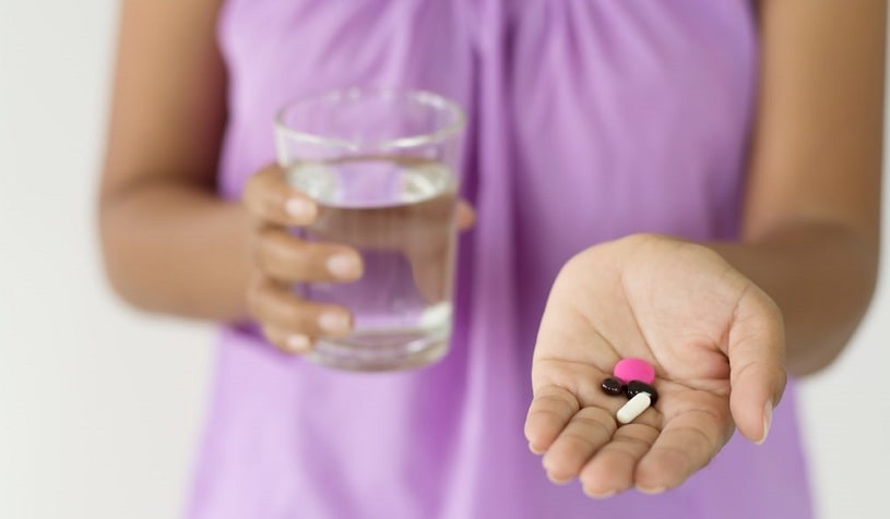 Woman holding the medications in her hand.
