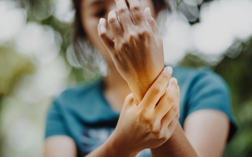 Young woman with pain in her wrist.